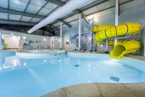 Indoor swimming pool with yellow flume slide at Bi