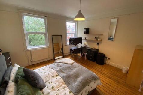 A bright and inviting master bedroom featuring ...