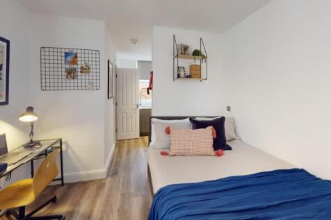 A bright and inviting double bedroom featuring ...