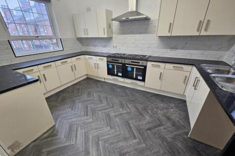 Bright modern kitchen with abundant worktop spa...