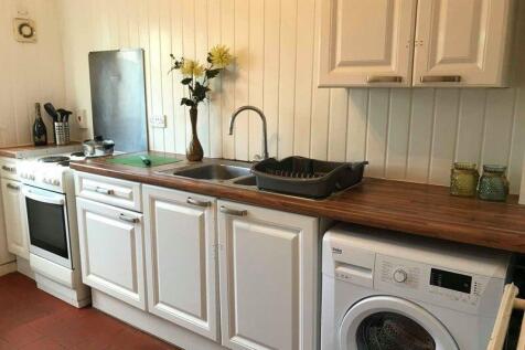 A clean, well-maintained kitchen featuring whit...