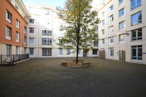 Spacious modern courtyard with central tree...