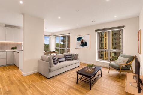 Explore this inviting apartment living area with a modern aesthetic and ample natural light.