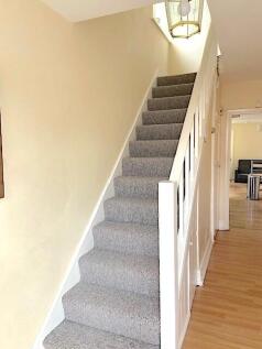 Bright, well-maintained entrance with carpeted ...