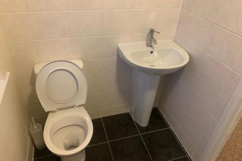 A tidy and well-maintained single toilet with m...