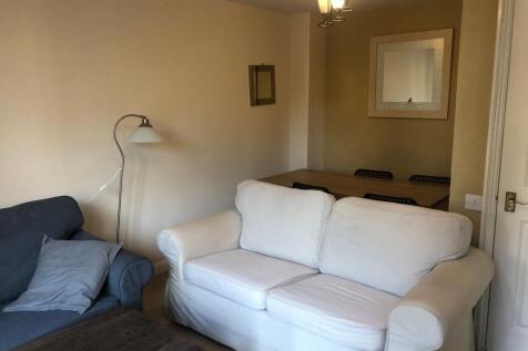 Bright, cozy living room with comfortable sofas...