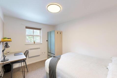A small, clean bathroom with a toilet, featurin...