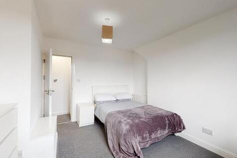 Bright, neutrally decorated double bedroom with...