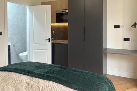 Stylish bedroom with a cozy double bed, built-i...