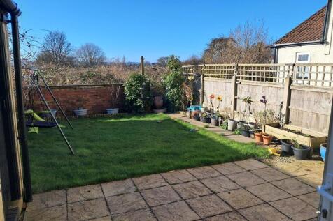 Secure rear garden with outhouse for storage