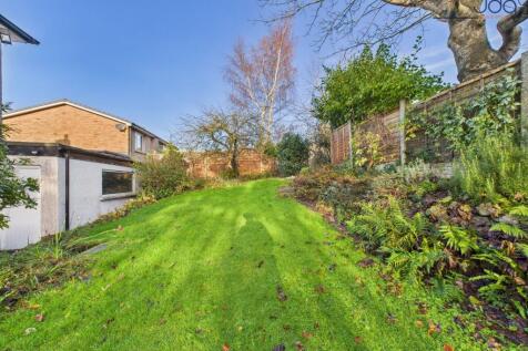Spacious Garden with a mixture of lawn, mature shrubs, fruit trees and flagstone seating area.