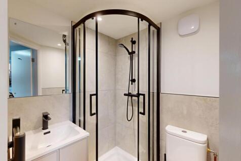 A modern, clean bathroom featuring a spacious s...