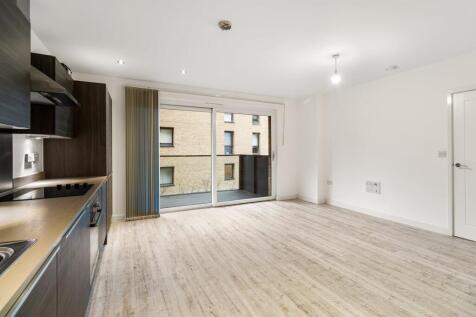 Step into this stylish open-plan apartment, featuring a sleek kitchen and ample light.