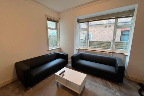 Bright, uncluttered living room with two matchi...