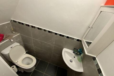 Modern toilet with sleek grey wall tiling...