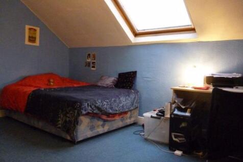 A cozy bedroom with a double bed, featuring a s...