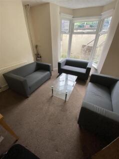 Bright lounge with ample seating and bay window...