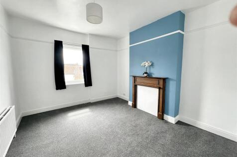 Bright bedroom with stylish blue feature wall...