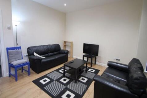 A cozy living room featuring two black leather ...