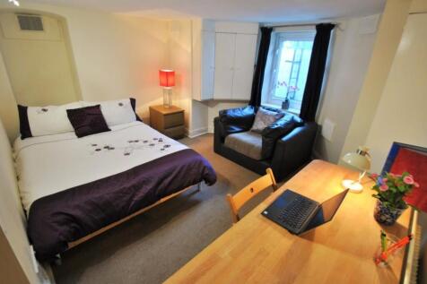 Spacious bedroom with study desk and cozy chair...