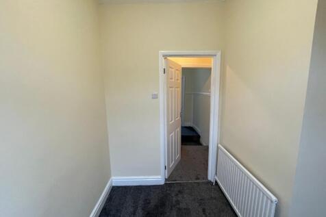 Bright and tidy hallway with fresh neutral deco...
