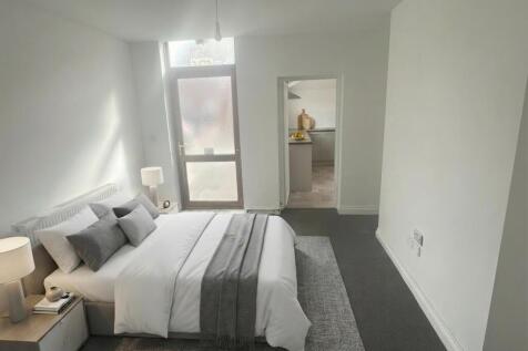 Bright, modern bedroom with large double bed...