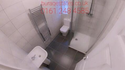Modern tiled bathroom with a shower cubicle, to...