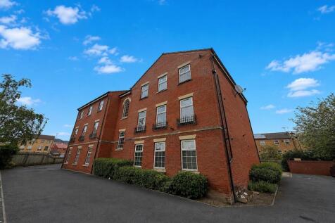 Grand red brick building under a clear blue sky...