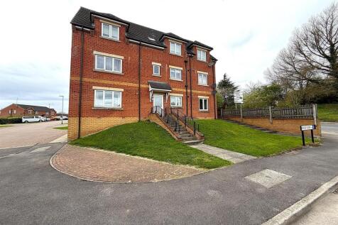 Modern brick exterior with lush green lawn...