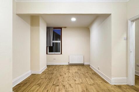 Bright, freshly painted rectangular bedroom wit...