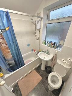 Bright, practical bathroom with a shower-over-b...