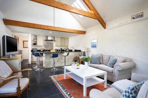 The open plan kitchen living space has vaulted ce
