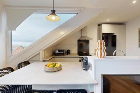 Bright and modern living room with ample natura...
