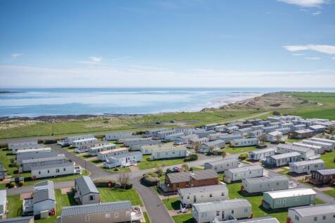 Aerial view of Amble Links Holiday Park beside the