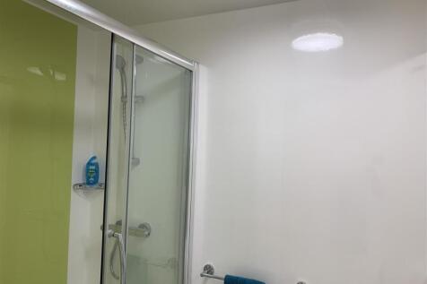 Modern shower cubicle with sleek lime accents...