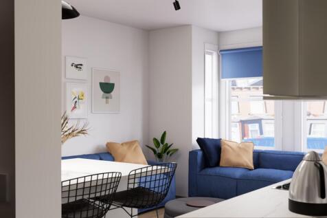 Bright, modern living area with blue sofas and ...