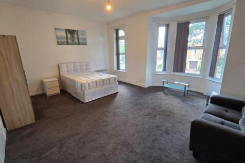 Spacious, bright bedroom with a double bed, lar...