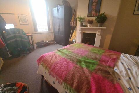 A cozy bedroom featuring a comfortable bed with...