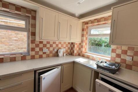 Bright fitted kitchen with double windows...