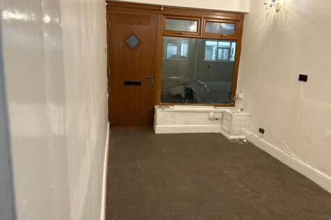 Narrow front room with street-facing window and...