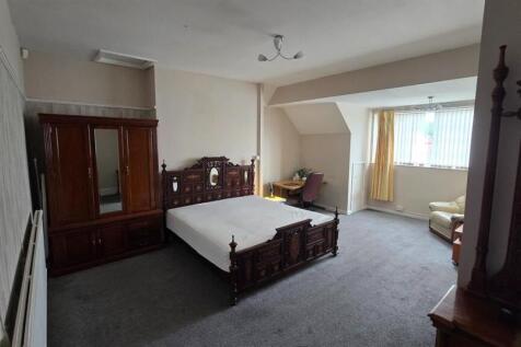 Spacious master bedroom with desk and wardrobe...