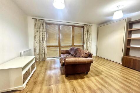 Spacious living area with wood laminate floors...