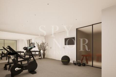 Contemporary real estate property private home gym in Carvoeiro featuring exercise machines dumbbells and modern design