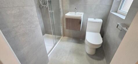 Modern tiled bathroom with sleek glass shower...