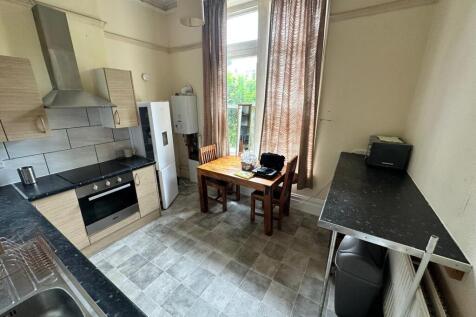 Bright eat-in kitchen with tiled flooring, fitt...
