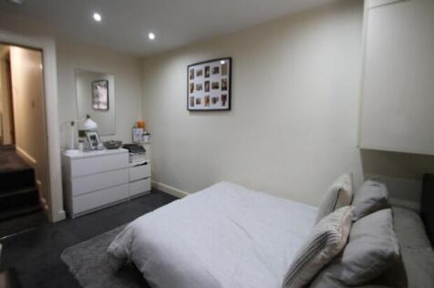 A spacious, well-maintained master bedroom feat...