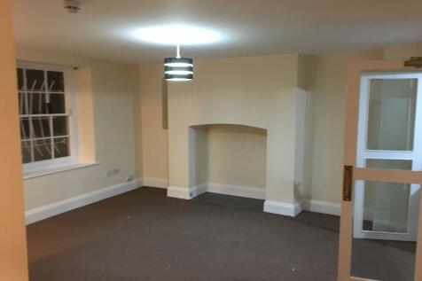 Spacious, neutral-toned living room with a cent...