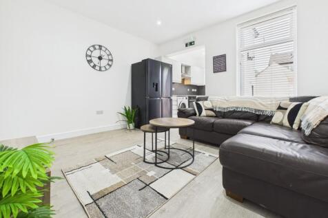 Bright and spacious living room featuring comfo...