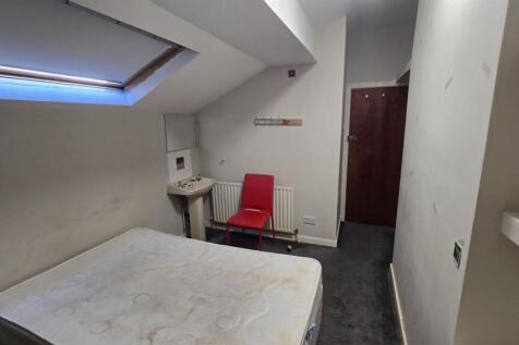 Cozy bedroom with a skylight and double bed....