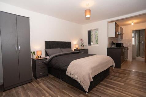 Spacious double bedroom featuring a comfortable...